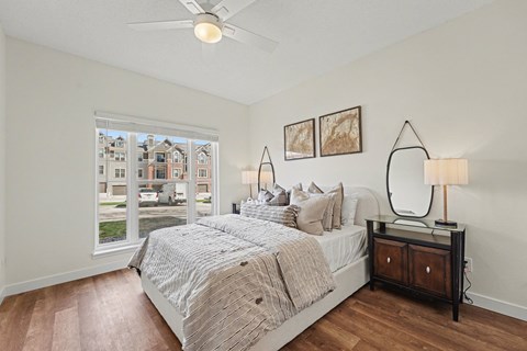 A bedroom with a large bed and a ceiling fan.