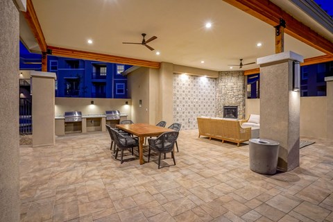 A dining area with a table surrounded by chairs.