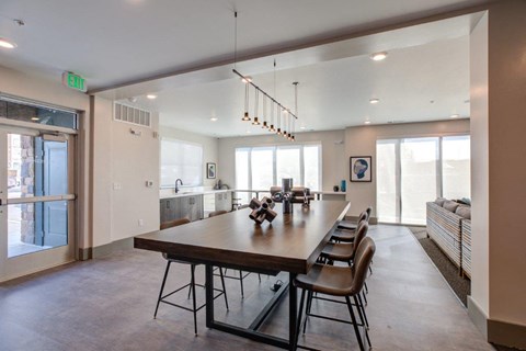A large dining room with a long table and chairs.