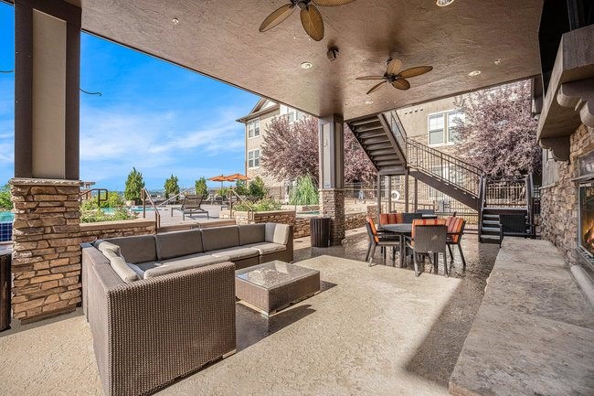 A patio with a couch, chairs, and a table.