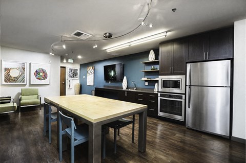 A modern kitchen with a dining table and chairs.