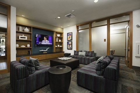 A living room with a television and a couch.