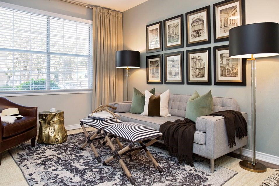 Model living room couch under gallery wall