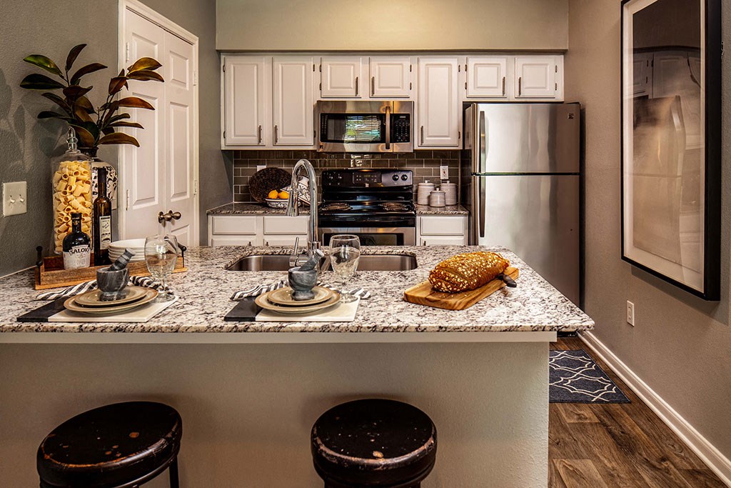 Furnished kitchen model with fridge and stove  at The Villages of Briar Forest, Houston, 77077