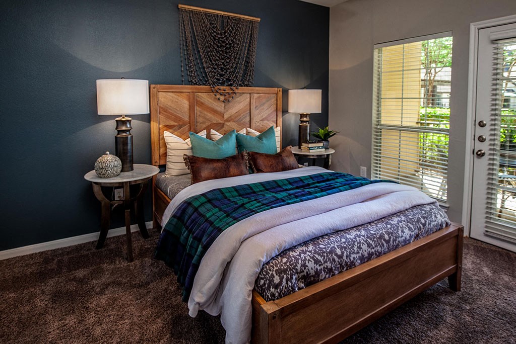 Furnished bedroom model with door to balcony  at The Villages of Briar Forest, Houston, TX