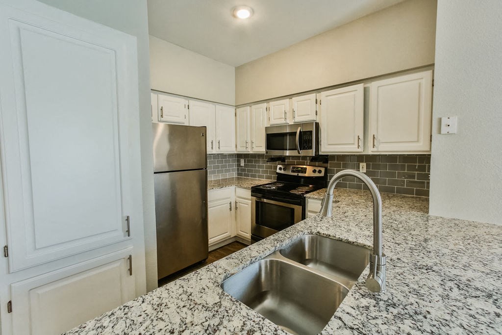 White Oak Floorplan kitchen with  sink and microwave  at The Villages of Briar Forest, Houston