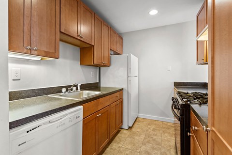 a kitchen with white appliances and wooden cabinets