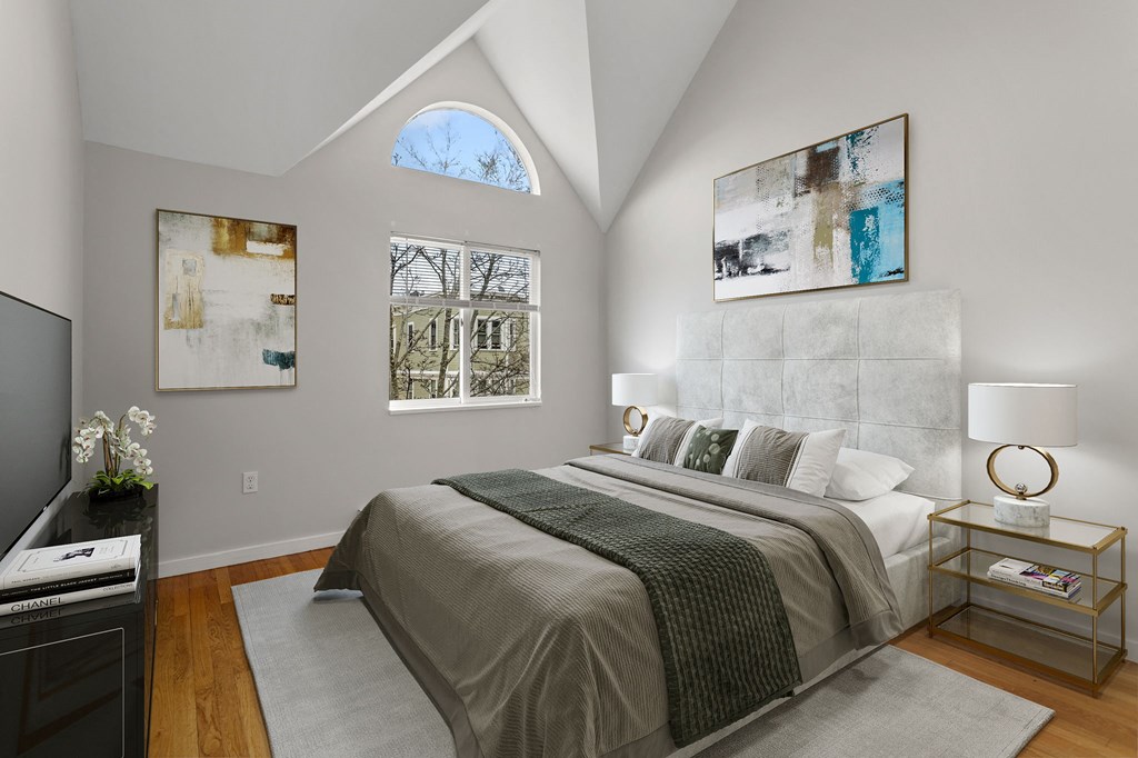 a bedroom with a bed and a large window