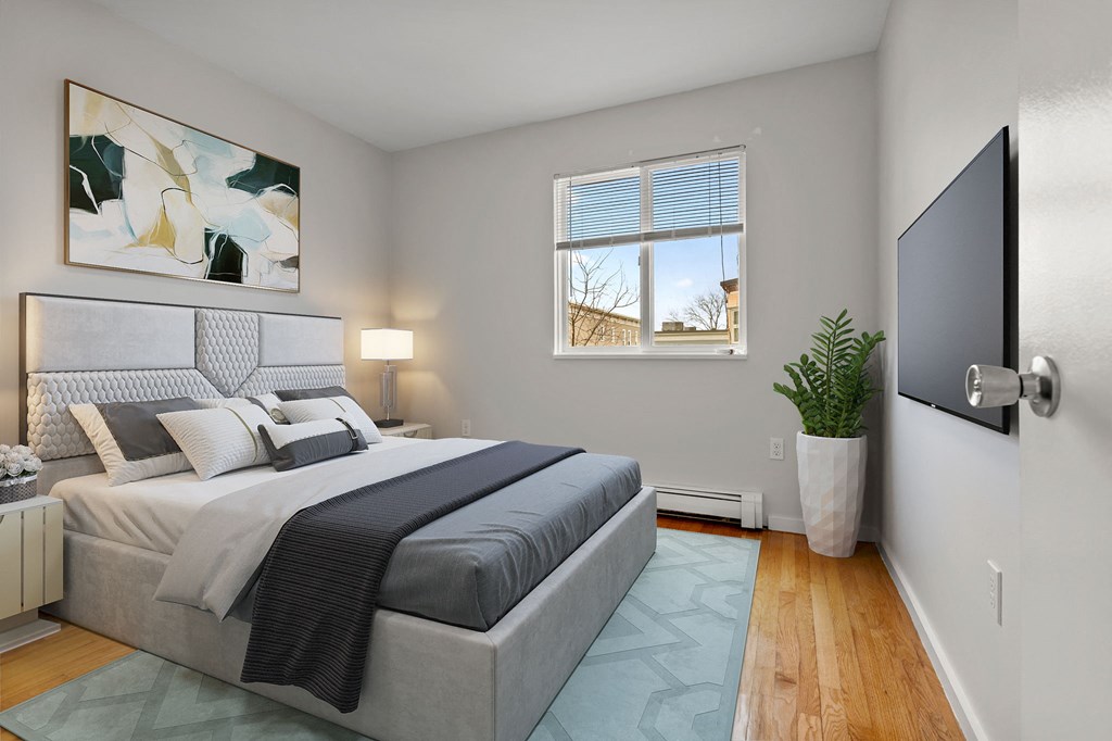 a bedroom with a bed and a window