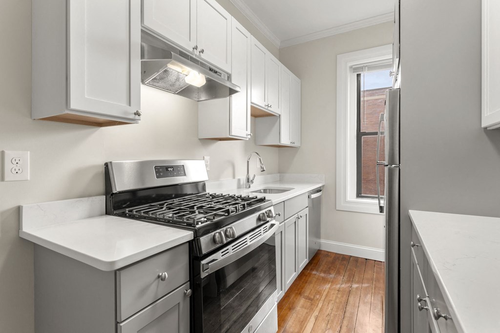 a kitchen with stainless steel appliances and white cabinets