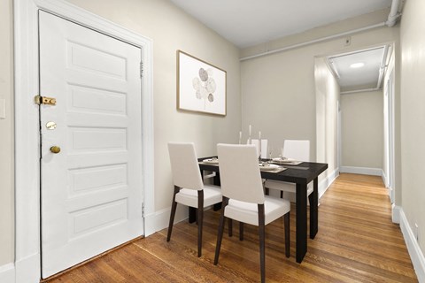 a dining room with a table and chairs and a white door