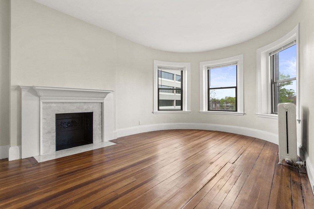 a living room with a fireplace and wood floors