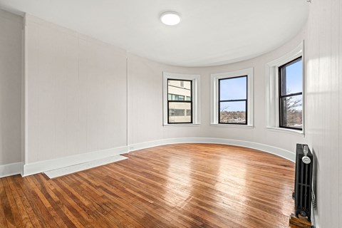 A room with a wood floor and a white ceiling.