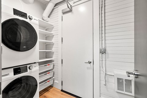 440-7 a washer and dryer in a laundry room with a white door