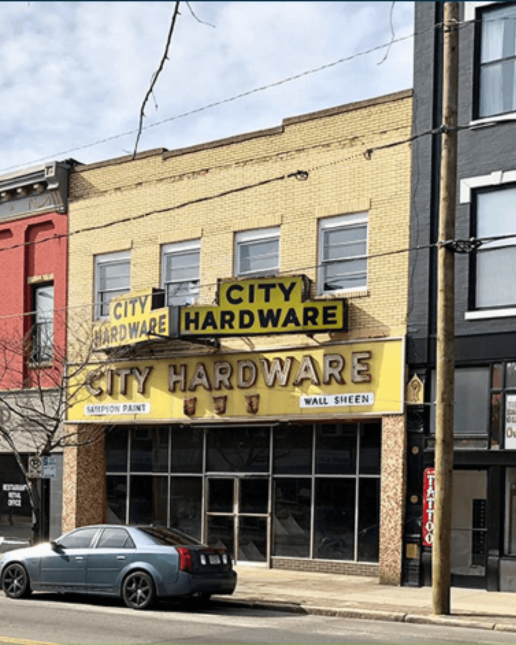 a city hardware store on the corner of a city street