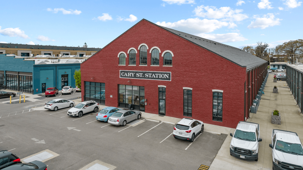 a large brick building with cars parked in front of it