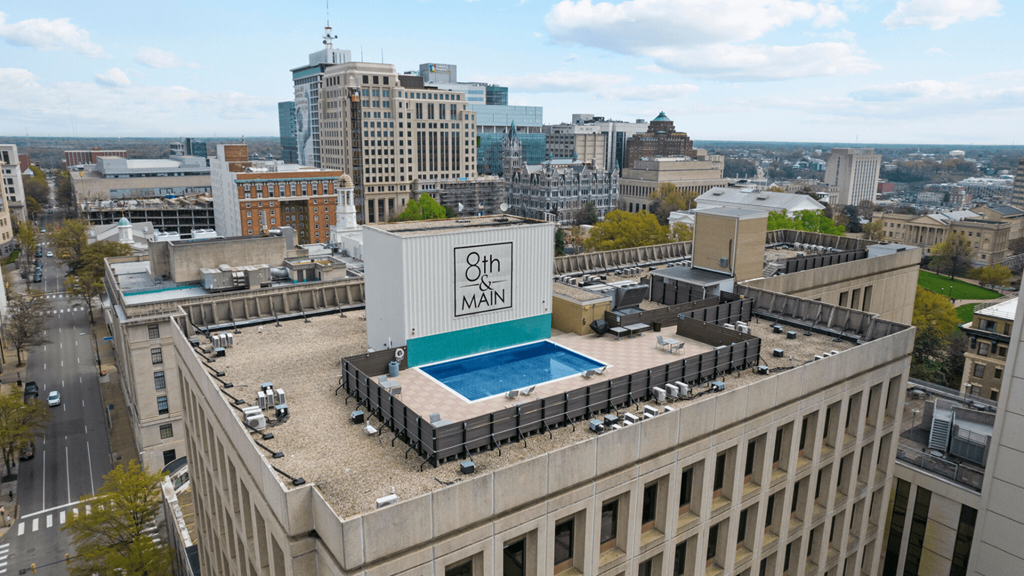 a swimming pool on the roof of a building in a city