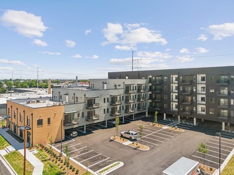 an overhead view of an apartment complex with a parking lot