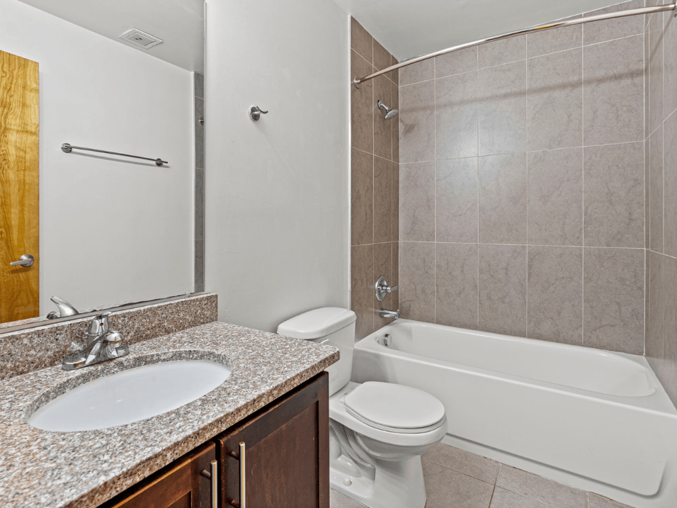 a bathroom with a sink toilet and a tub