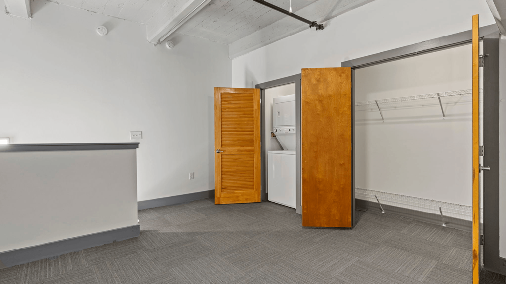 a room with a bathroom and a door to a closet