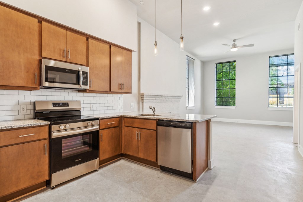 a large kitchen with wooden cabinets and stainless steel appliances