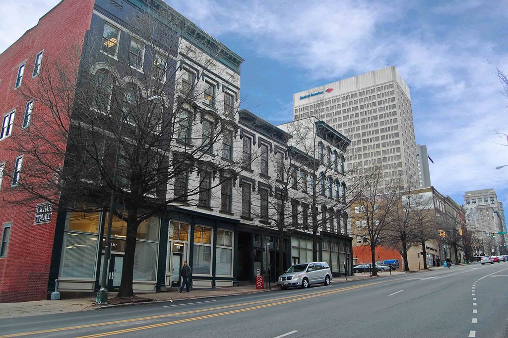 Exchange Place Apartments Exterior, with city skyline in background