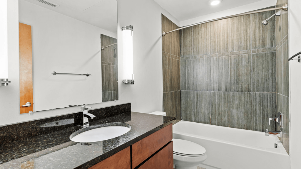 a bathroom with a sink and a shower and a toilet