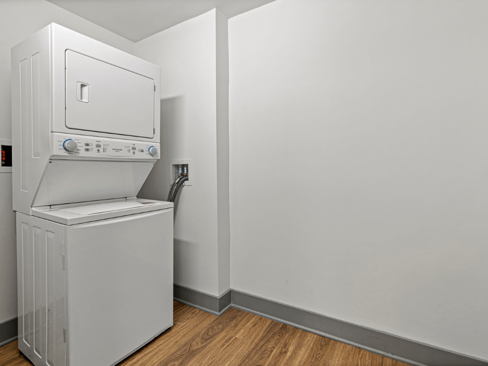 a washer and dryer in the corner of a room with a white wall