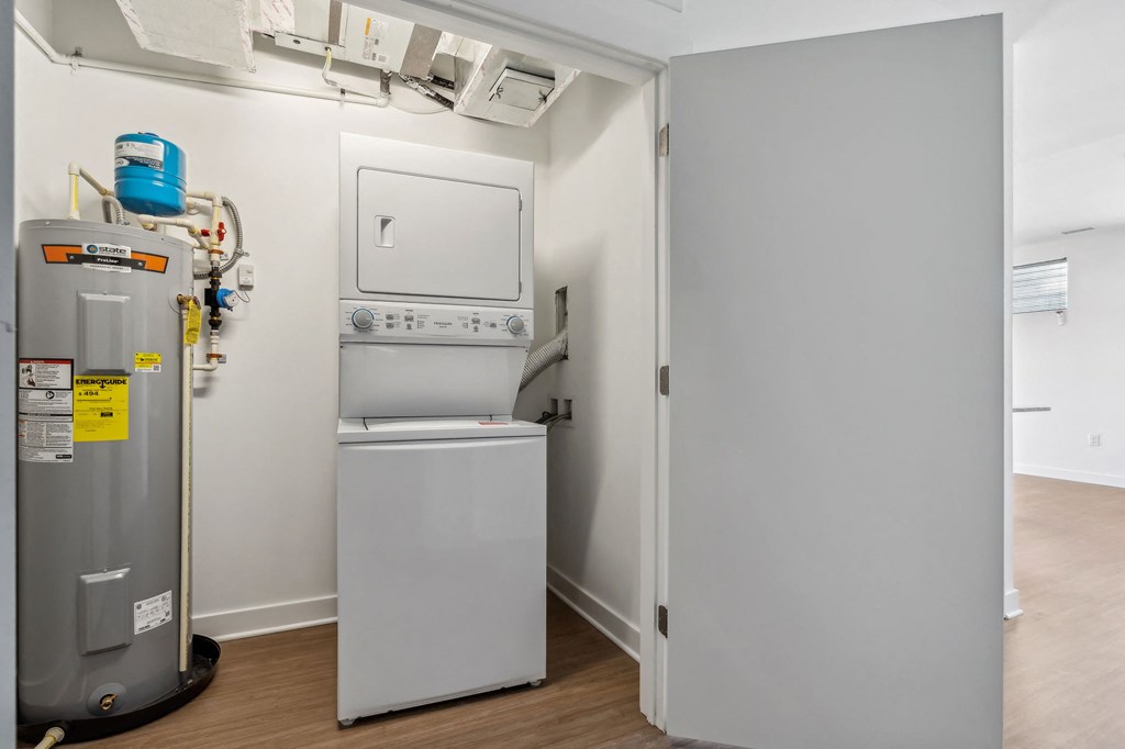a small laundry room with a washer and dryer and a refrigerator