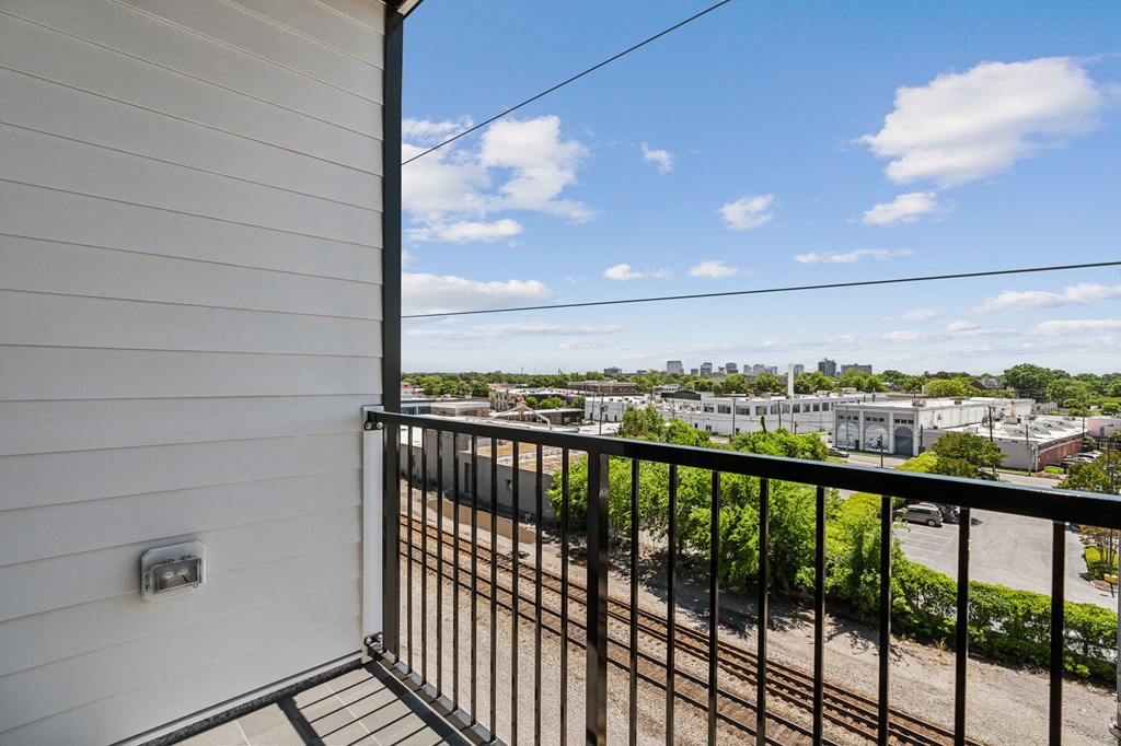 the view of the city from the balcony of a condo