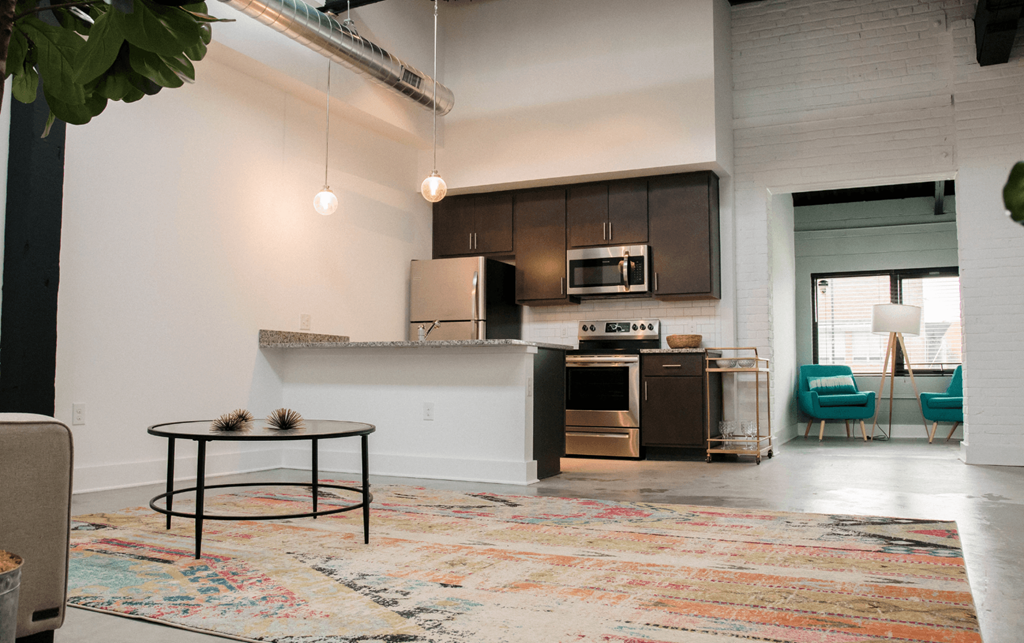 a living area with a kitchen and a table