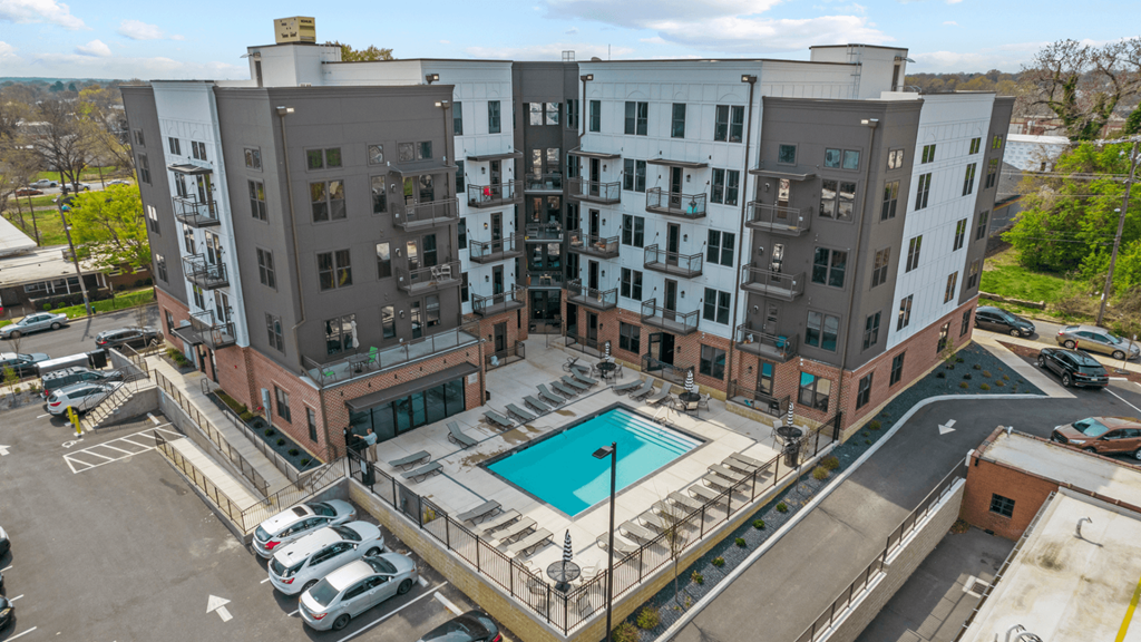 an aerial view of an apartment building with a swimming pool