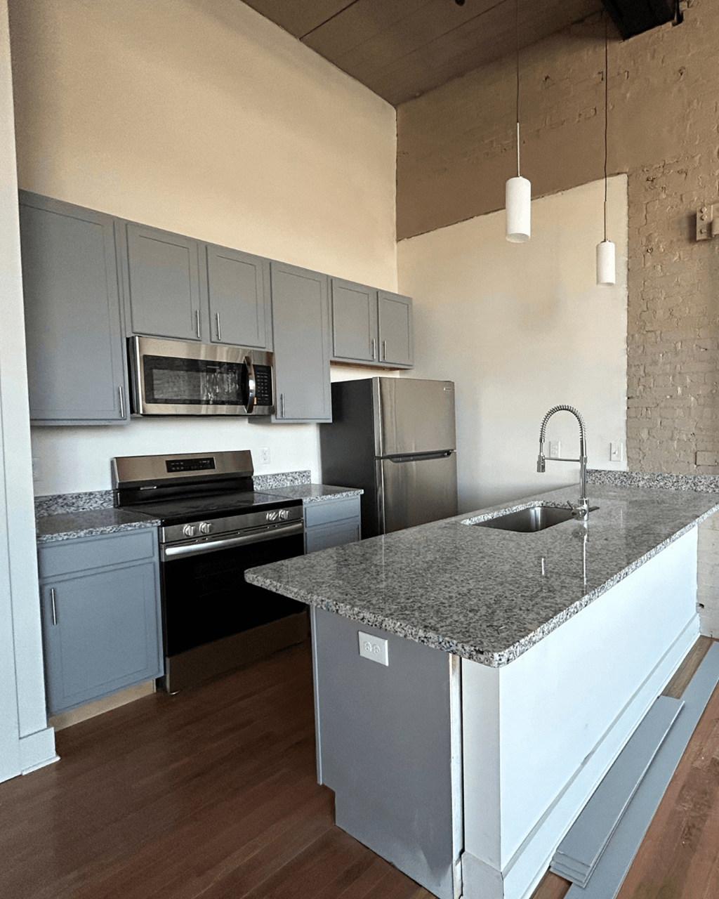 a kitchen with granite counter tops and stainless steel appliances