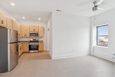 A kitchen with a refrigerator, oven, and microwave.