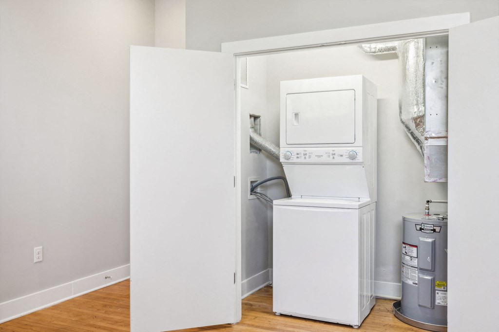 a small laundry room with a washer and dryer in it and a door