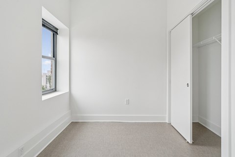 A white room with a window and a door.