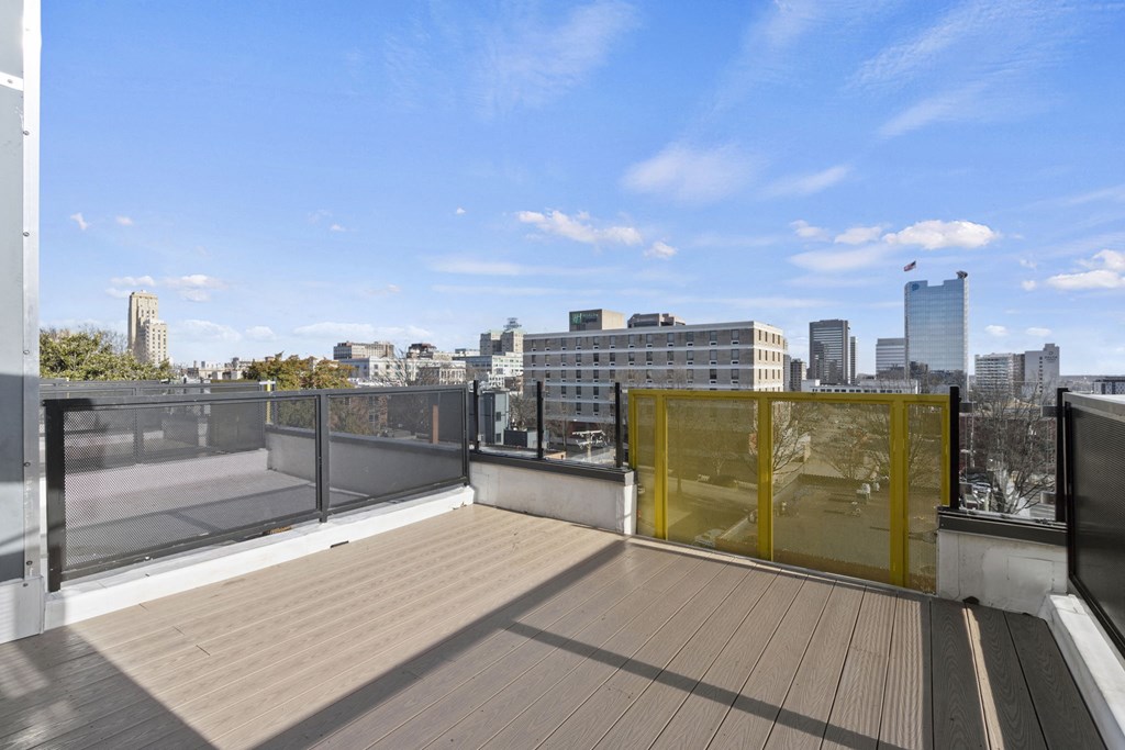 a rooftop deck with a view of the city