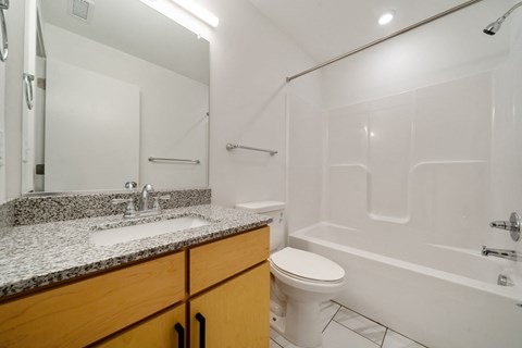 A white bathroom with a sink, toilet, and bathtub.