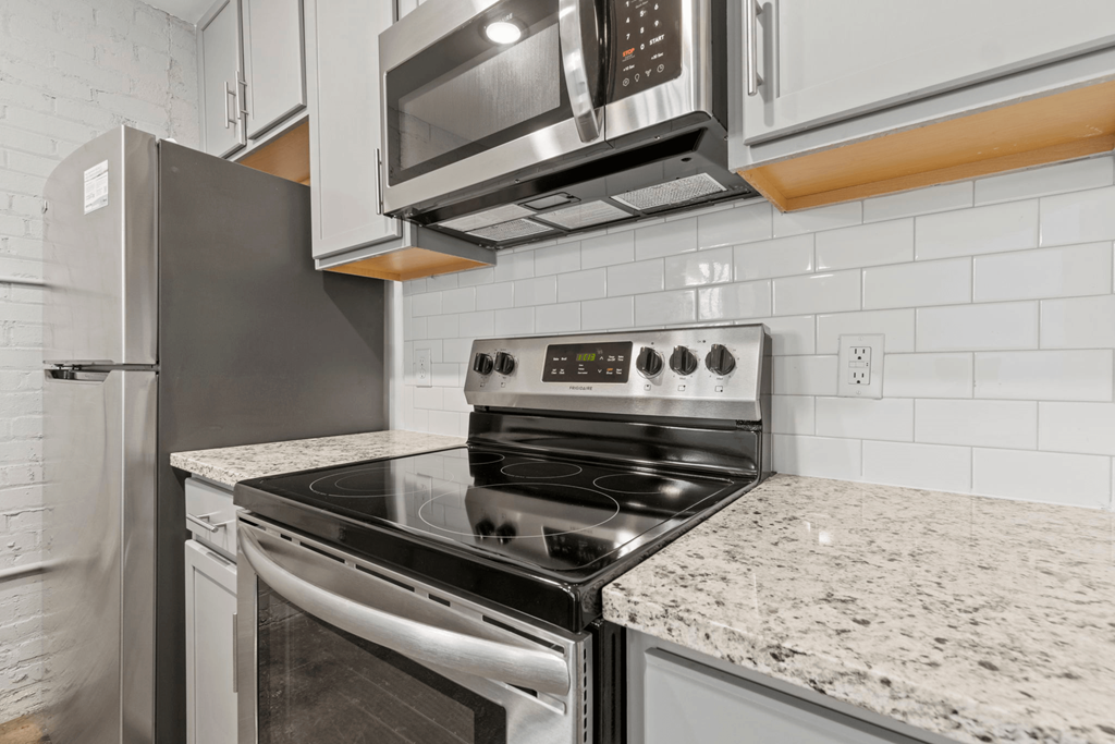 a kitchen with granite counter tops and stainless steel appliances