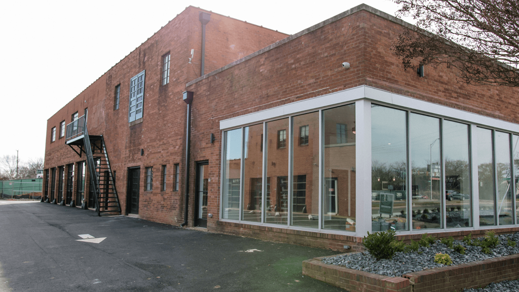 the exterior of a brick building with large windows