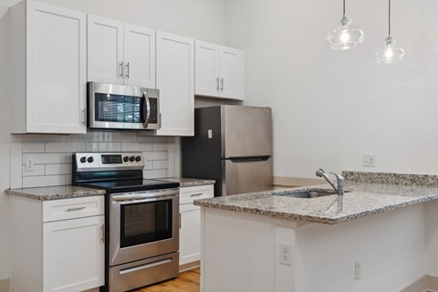 a kitchen with granite counter tops and stainless steel appliances