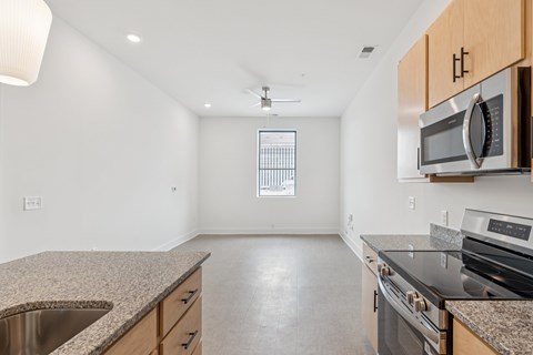 A kitchen with granite countertops and stainless steel appliances.