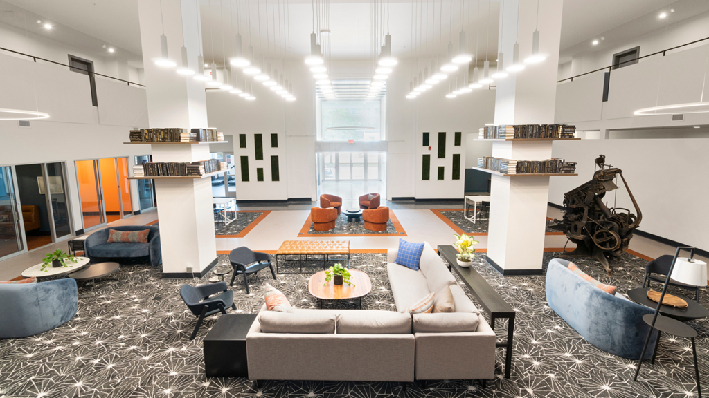 a large living room with couches and chairs and a table