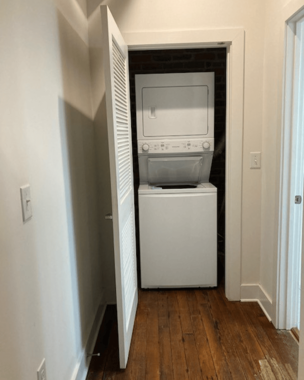 a white washer and dryer in a small room