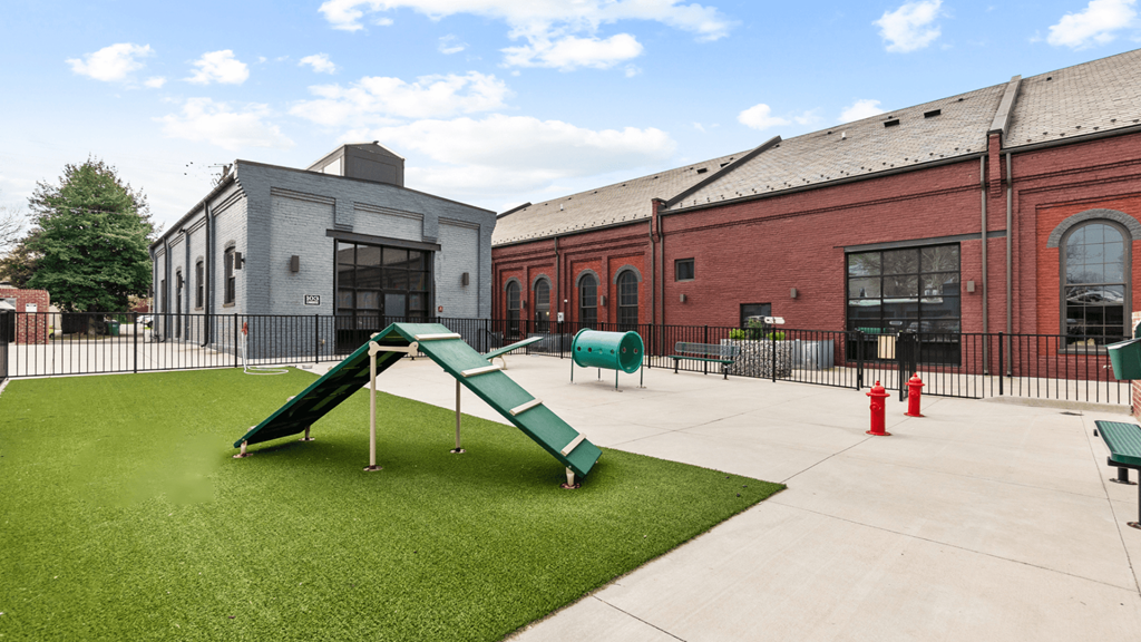 a playground in the courtyard of a building with a slide