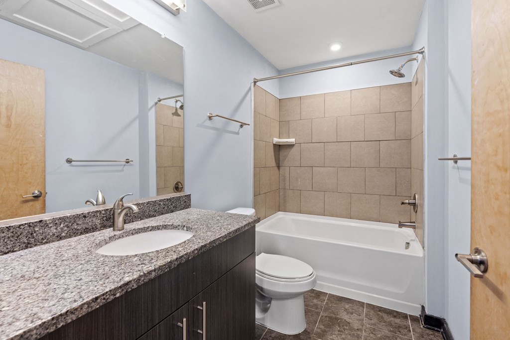 a bathroom with a sink toilet and shower and a tub