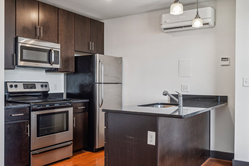 an empty kitchen with stainless steel appliances and a counter top