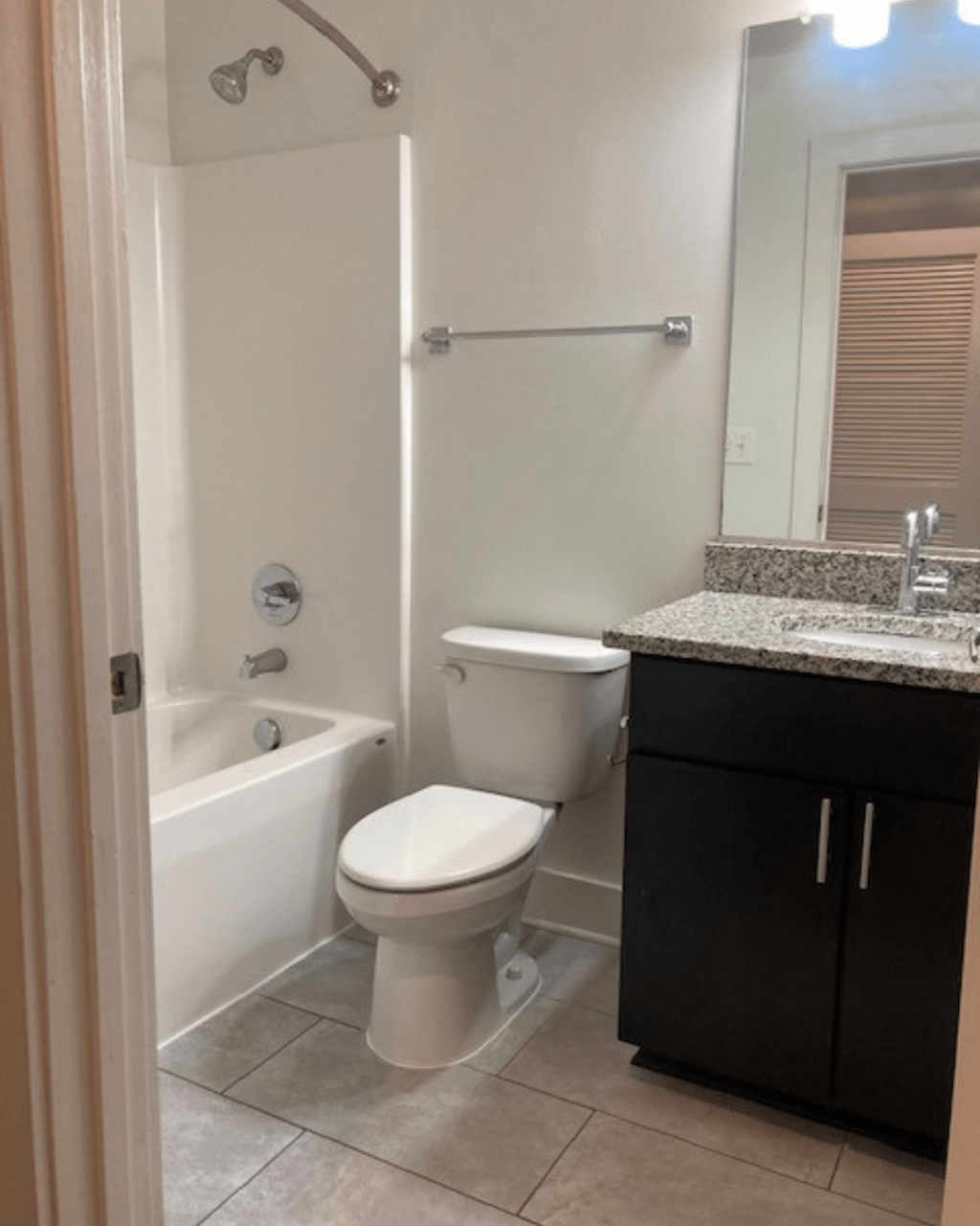 a bathroom with a toilet and a tub and a sink