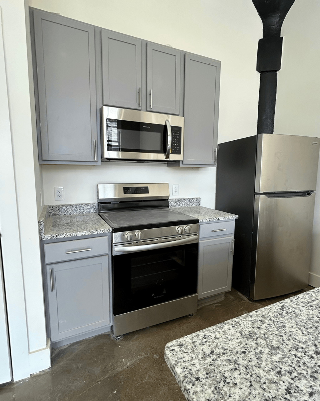 a kitchen with stainless steel appliances and white cabinets