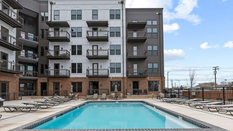 a swimming pool in front of an apartment building